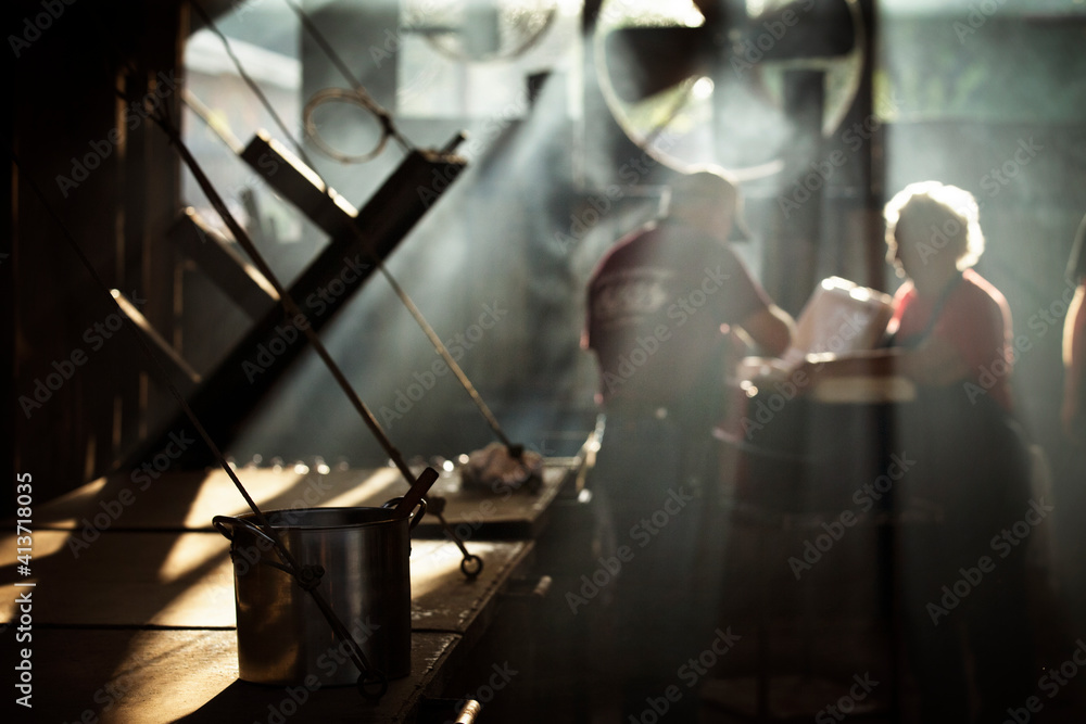 Workers cooking food in kitchen at restaurant Workers cooking food in kitchen at restaurant