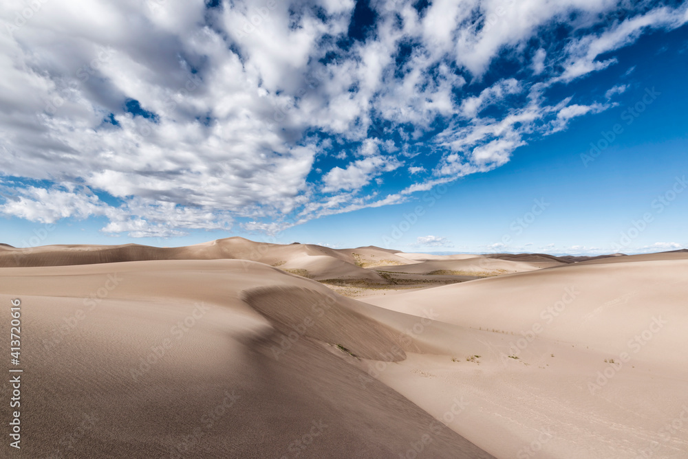 Desert landscape against cloudy sky Desert landscape against cloudy sky