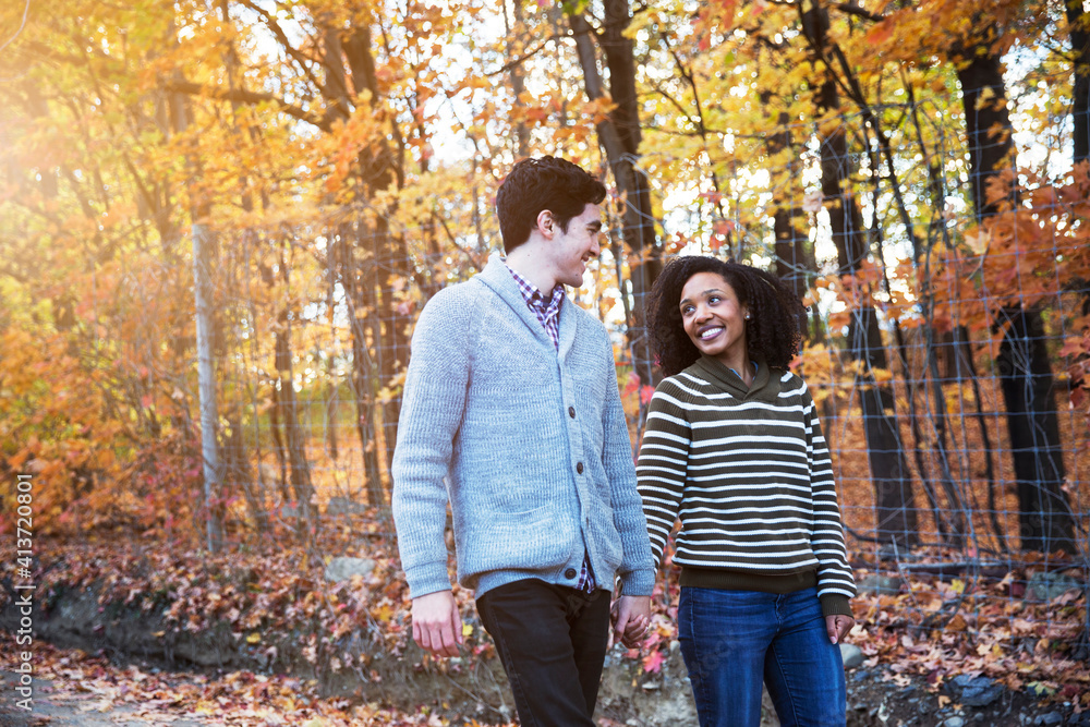 Couple talking while walking in forest Couple talking while walking in forest