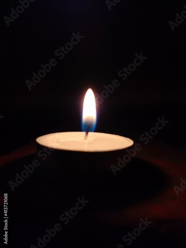 candle glowing in the dark background 