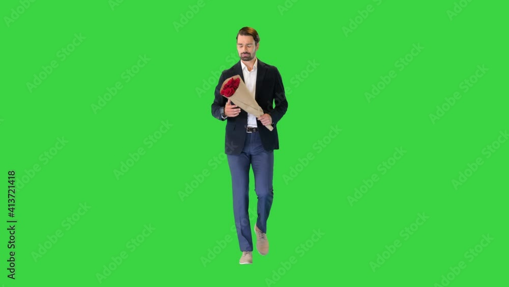 Man walking and looking at watch and holding flowers on a Green Screen, Chroma Key. Man walking and looking at watch and holding flowers on a Green Screen, Chroma Key.