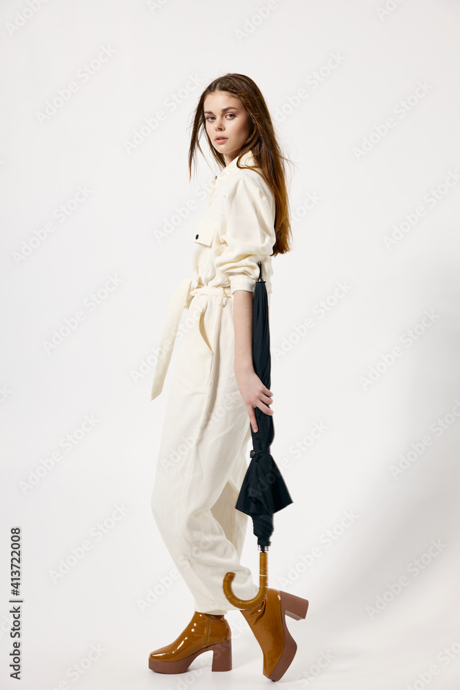 woman holding umbrella in hands white suits fashion