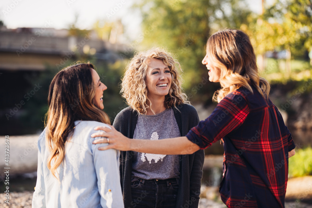 Happy female friends talking standing outdoors Happy female friends talking standing outdoors