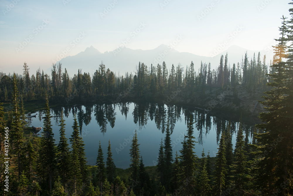 Lake amidst trees at sawtooth range against sky Lake amidst trees at sawtooth range against sky