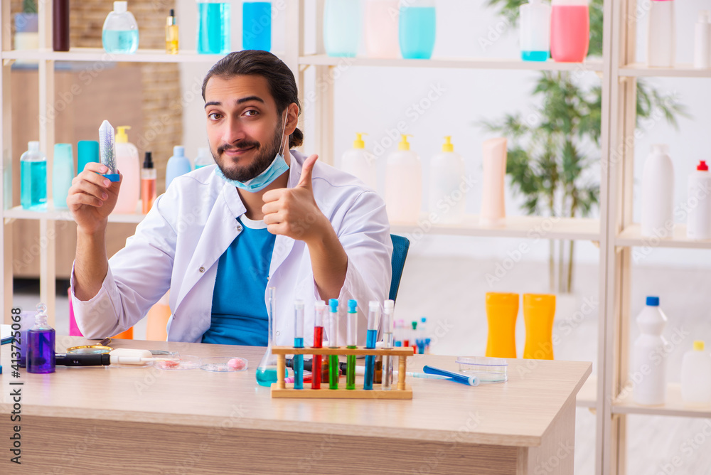 Young male chemist testing soap in the lab Young male chemist testing soap in the lab