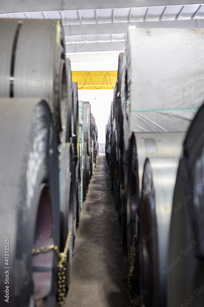 Rolled up metal sheets arranged in row at Steel Mill Rolled up metal sheets arranged in row at Steel Mill