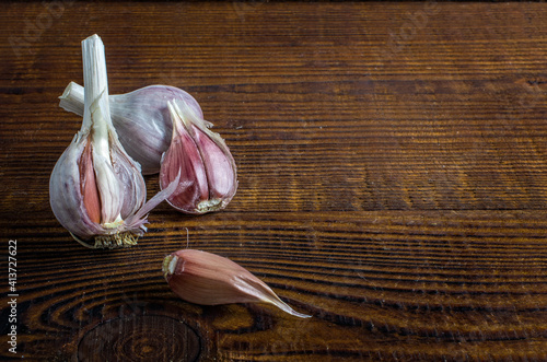 heads of garlic on a wood board. Rustic style photo