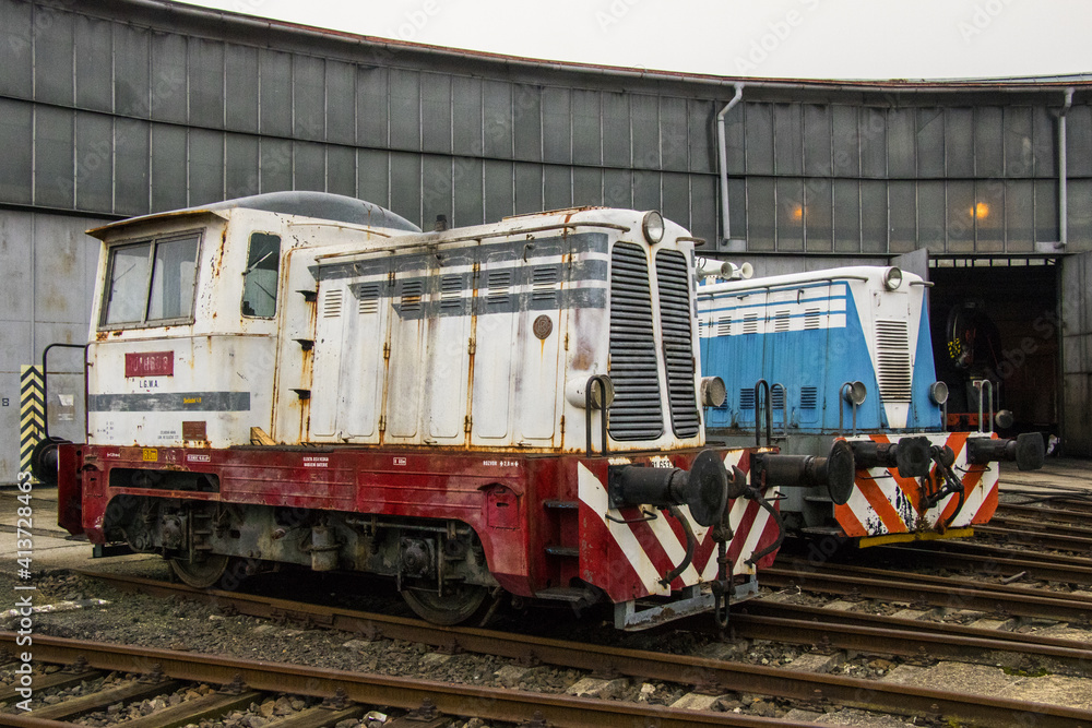 small motor locomotive resting in a railway depot