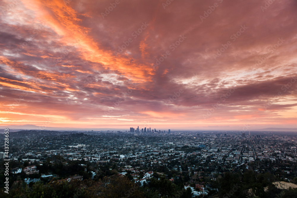 Aerial view of cityscape against cloudy sky during sunset Aerial view of cityscape against cloudy sky during sunset