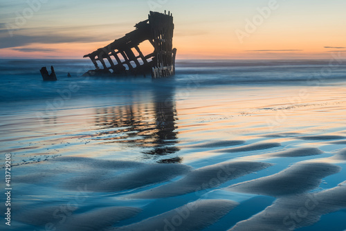 Wreck of the Peter Iredale against sky during sunset photo