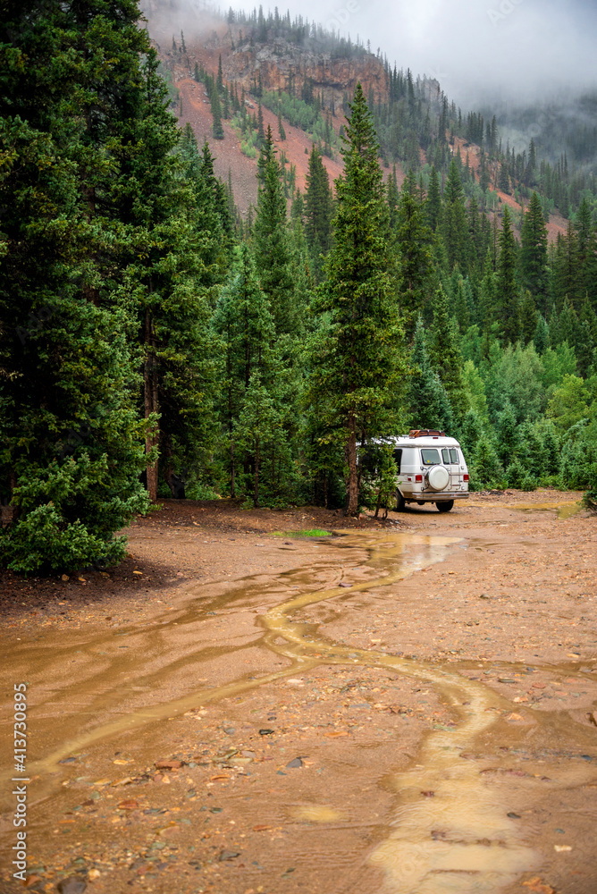 Motor home parked on wet field in forest Motor home parked on wet field in forest
