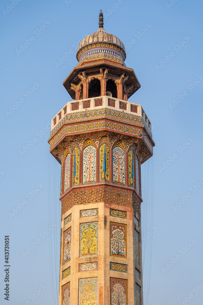 Colorful kashi-kari or faience mosaic decoration on minaret of mughal era Wazir Khan mosque in the walled city of Lahore, Punjab, Pakistan