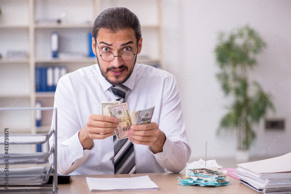 Young male bookkeeper in budget planning concept Young male bookkeeper in budget planning concept