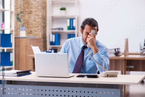 Young male employee working in the office