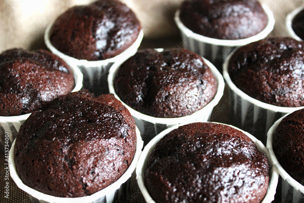 Chocolate muffins with nuts in white paper forms