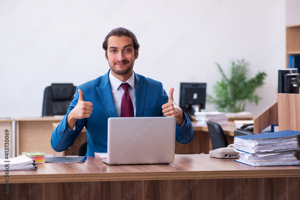 Young male employee working at workplace Young male employee working at workplace