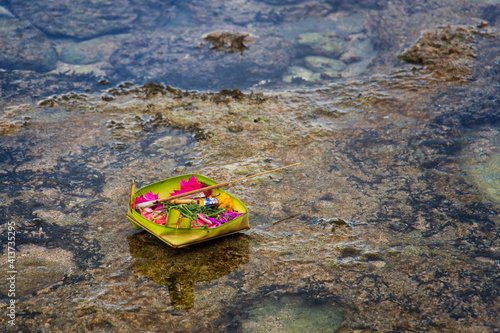 ritual offering drifting on a river photo