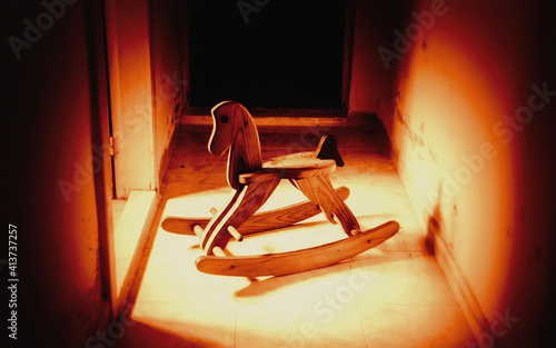 Obraz na plátně A creepy rocking horse, abandoned in a basement room