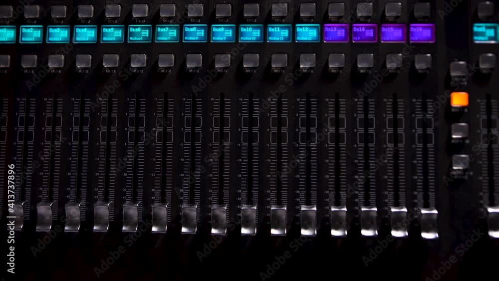 Detail of music mixer desk with various knobs and lighting buttons for tuning of stage close up. Mixing desk during concert. Professional Recording Studio. Interface of equipment for sound processing. Detail of music mixer desk with various knobs and lighting buttons for tuning of stage close up. Mixing desk during concert. Professional Recording Studio. Interface of equipment for sound processing.