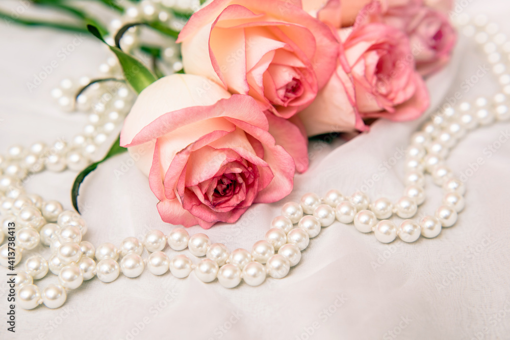 The branch of pink rose on white fabric background
The branch of pink rose on white fabric background