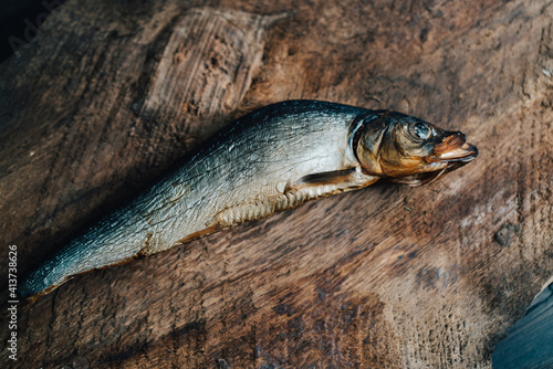 dried fish lies on a wooden table top view texture photo