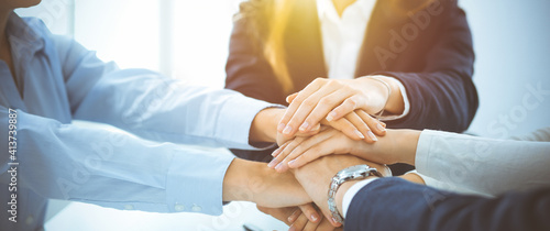 Obraz na płótnie Business team showing unity with their hands together in sunny office