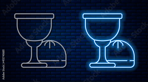 Glowing neon line Holy grail or chalice icon isolated on brick wall background. Christian chalice. Christianity icon. Vector.