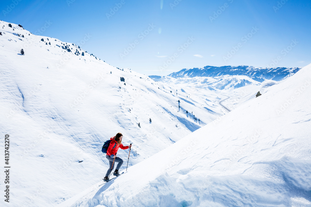 Female hiker climbing snow covered mountain at Joshua Tree National Park Female hiker climbing snow covered mountain at Joshua Tree National Park