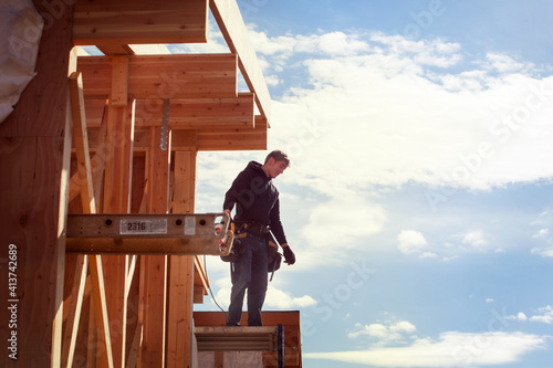 Wallpaper Mural Worker standing on wooden frame against sky during sunny day Torontodigital.ca