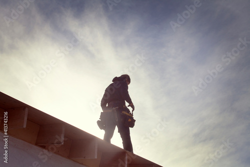 Low angle view of architecture standing on roof beam during sunny day photo