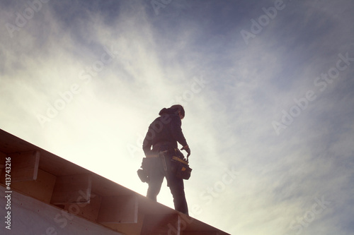 Low angle view of architecture standing on roof beam during sunny day