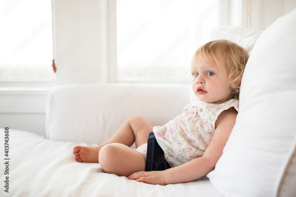 Girl looking away while relaxing on bed at home Girl looking away while relaxing on bed at home