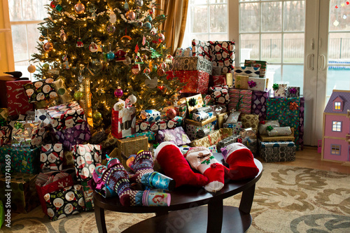 Various gifts and decorations by Christmas tree at home photo