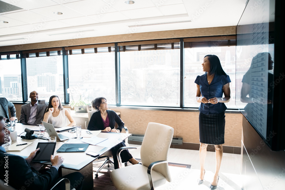 Businesswoman giving presentation in meeting at board room Businesswoman giving presentation in meeting at board room