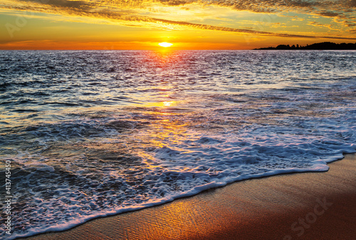 Sandy beach at sunrise photo