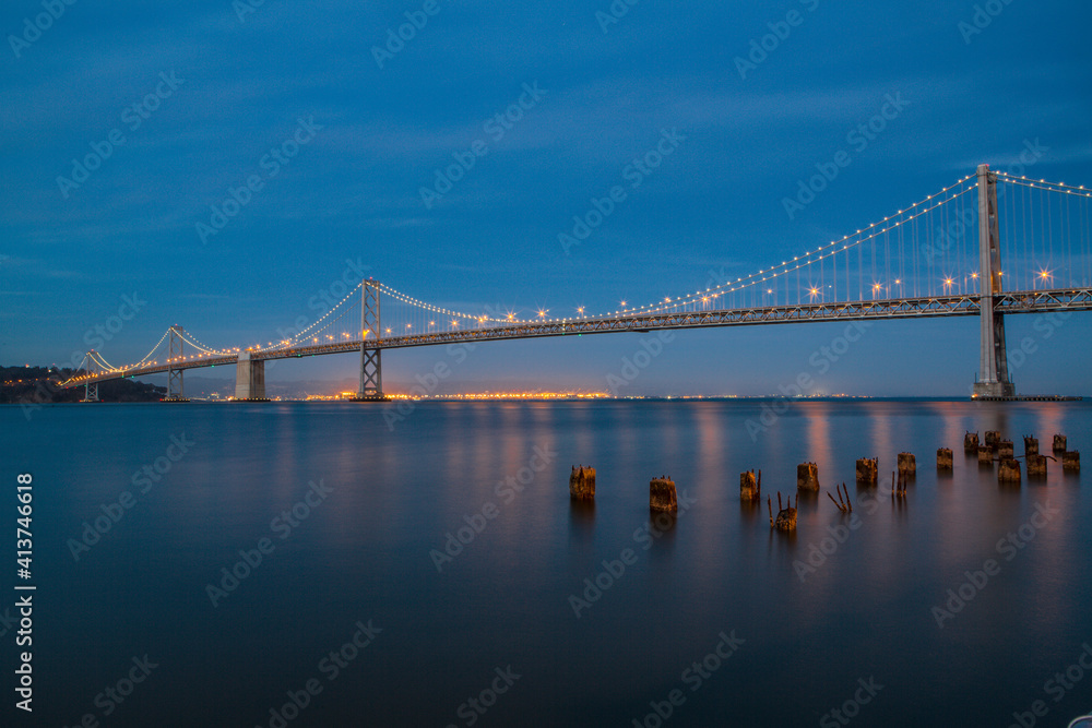 Illuminated Oakland Bay Bridge against blue sky at dusk Illuminated Oakland Bay Bridge against blue sky at dusk