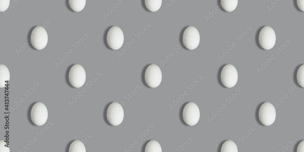 Seamless pattern with white chicken eggs on a gray background. Color of the year 2021 Ultimate Grey. Easter concept.