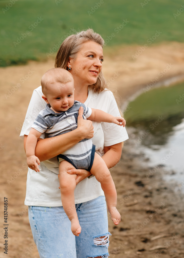 Fototapeta premium happy mother holding and hugging son