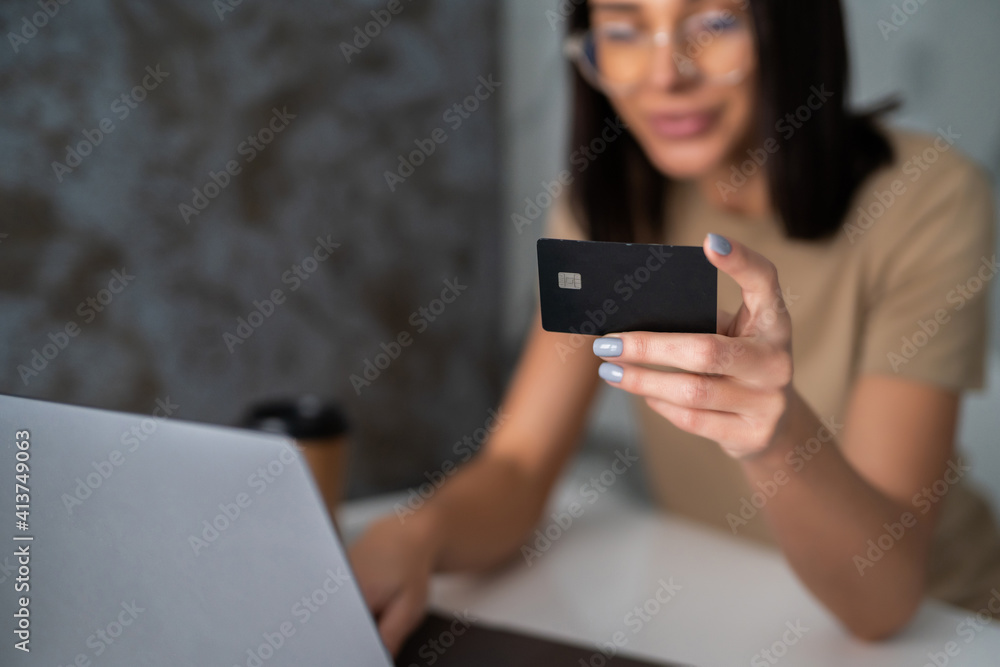 Happy woman shopping online with credit card and laptop. Internet Shopping Happy woman shopping online with credit card and laptop. Internet Shopping