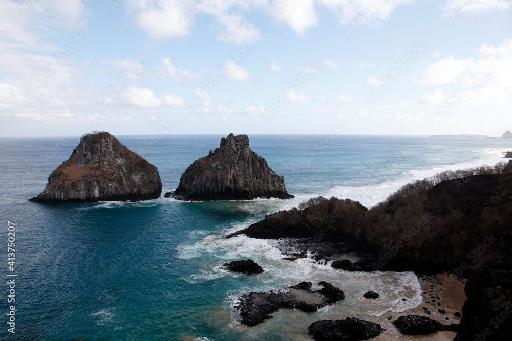 Scenic view of rock formations in sea at Fernando de Noronha against sky Scenic view of rock formations in sea at Fernando de Noronha against sky