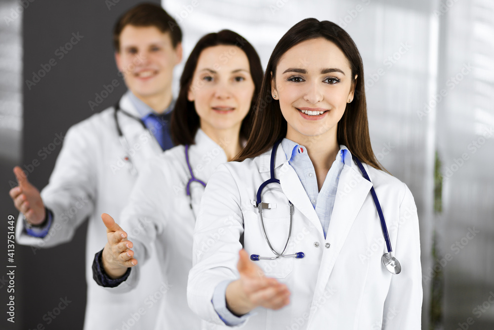 Doctors are standing as a team while offering their helping hands for shaking hand or saving people's life. Physicians are ready to help their patients. Medical help, insurance in health care, best Doctors are standing as a team while offering their helping hands for shaking hand or saving people's life. Physicians are ready to help their patients. Medical help, insurance in health care, best