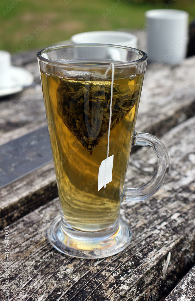 Green tea in a tall glass on a wooden table Green tea in a tall glass on a wooden table
