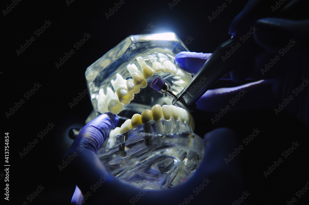 Dentist demonstrates how to polish teeth with a toothbrush Stock Photo