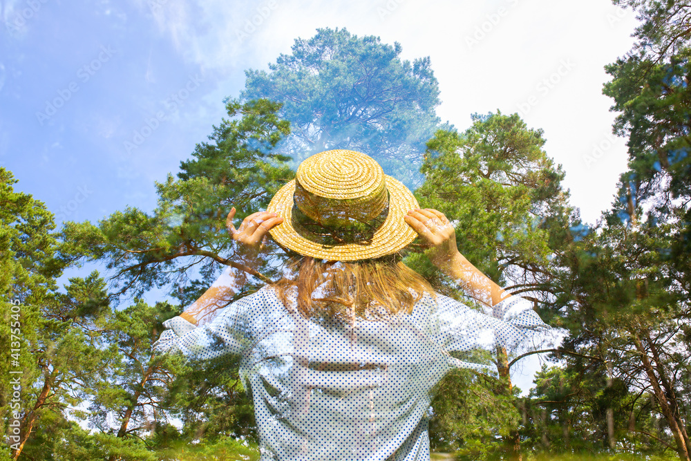 Hipster girl in straw hat in the forest. Multiple exposure photo. Wanderlust concept. Travelling ideas. Beautiful woman in the forest. Summer vibes. Freedom and psychology.