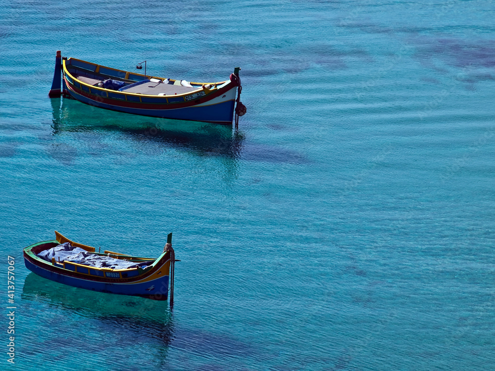 Traditional Maltese fishing boats in calm waters Traditional Maltese fishing boats in calm waters
