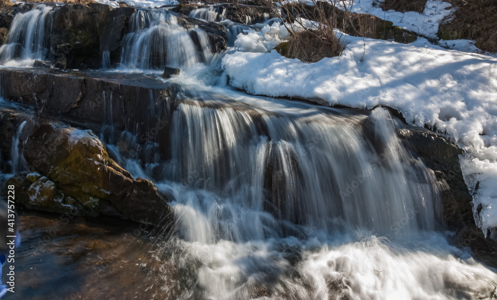 A small waterfall on the river in the spring A small waterfall on the river in the spring