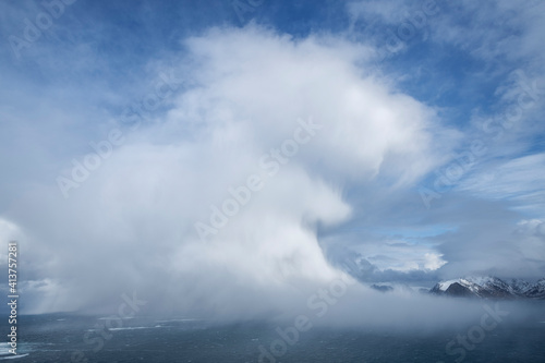 Winter snow flurry approaches from the sea, Flakstadøy, Lofoten Islands, Norway