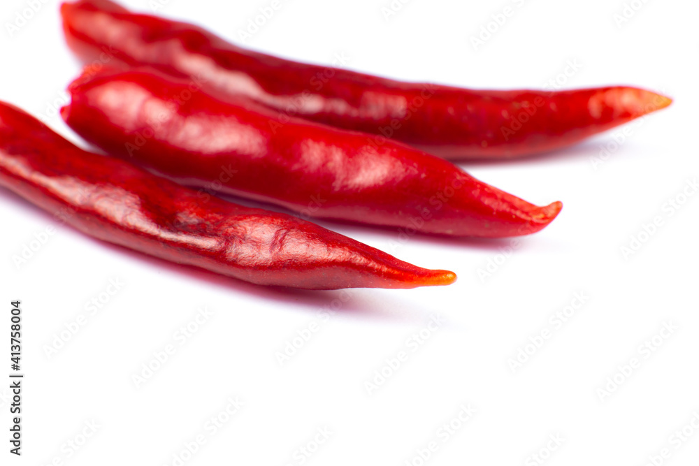 Red hot chili peppers on white background. Close up. Red hot chili peppers on white background. Close up.