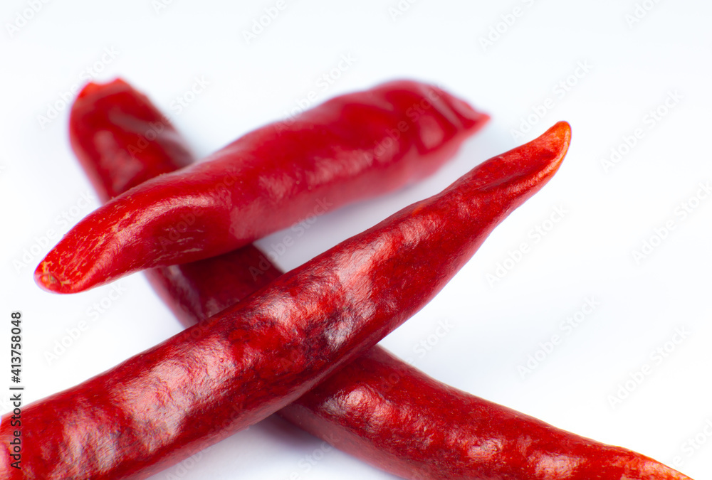Red hot chili peppers on white background. Close up. Red hot chili peppers on white background. Close up.