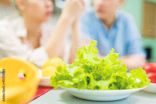 Fresh juicy green salad for breakfast for a young family.